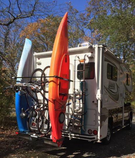Swing out Yakups brand racks for Motorhomes Vans and Truck campers Yakups RV Kayak Bike Boards Custom vertical rack www.Yakups